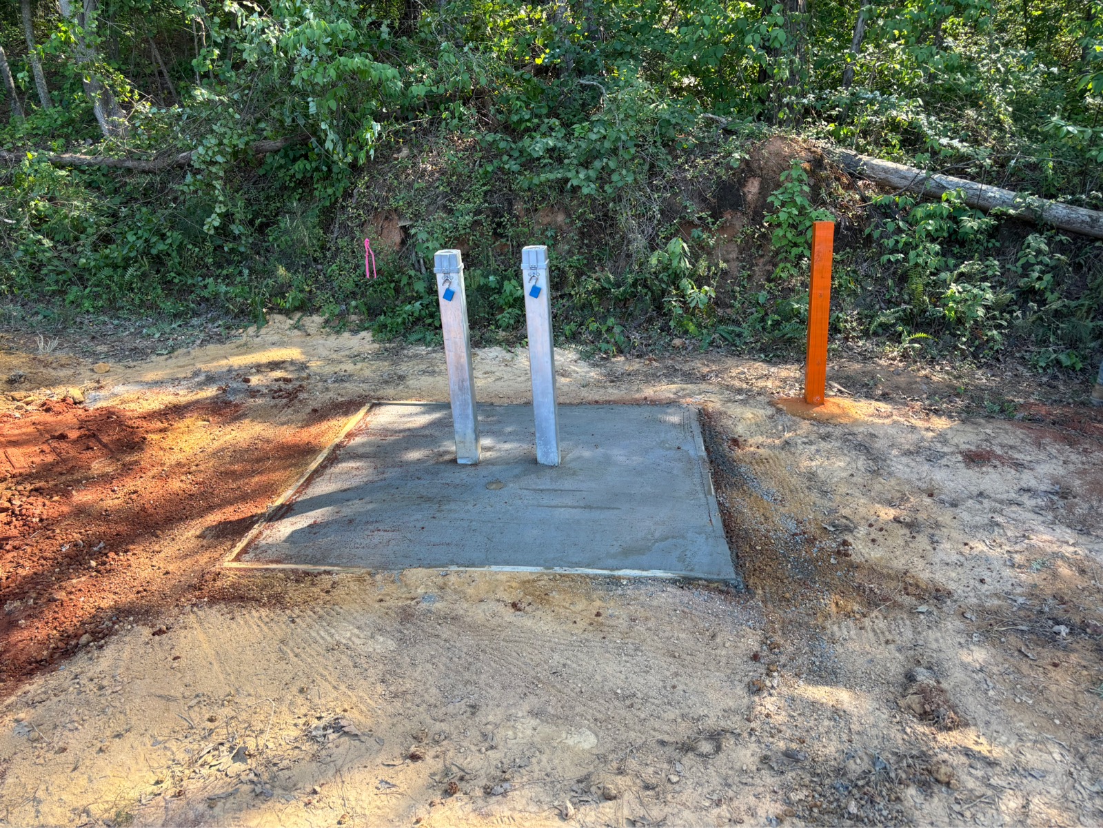 Vapor well being installed on an outdoor area near green trees.