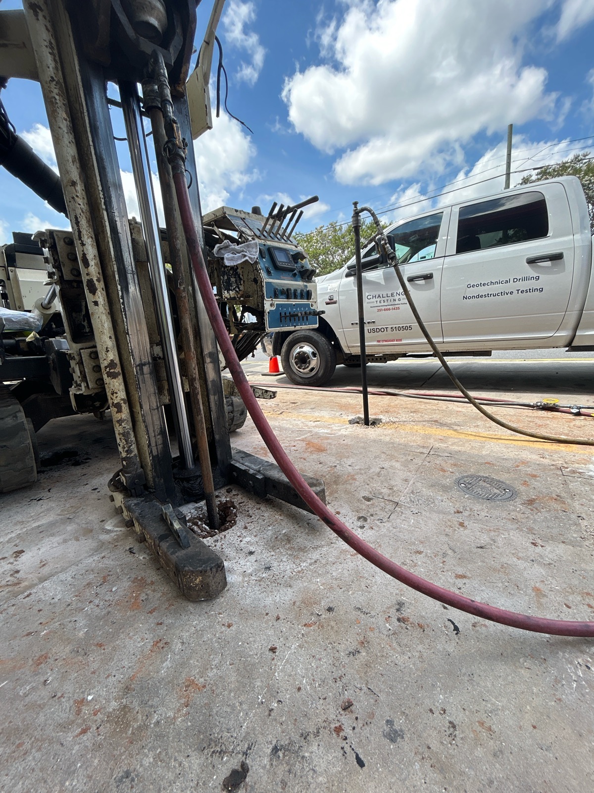 A Challenge Testing white truck parked next to an environmental injection well.